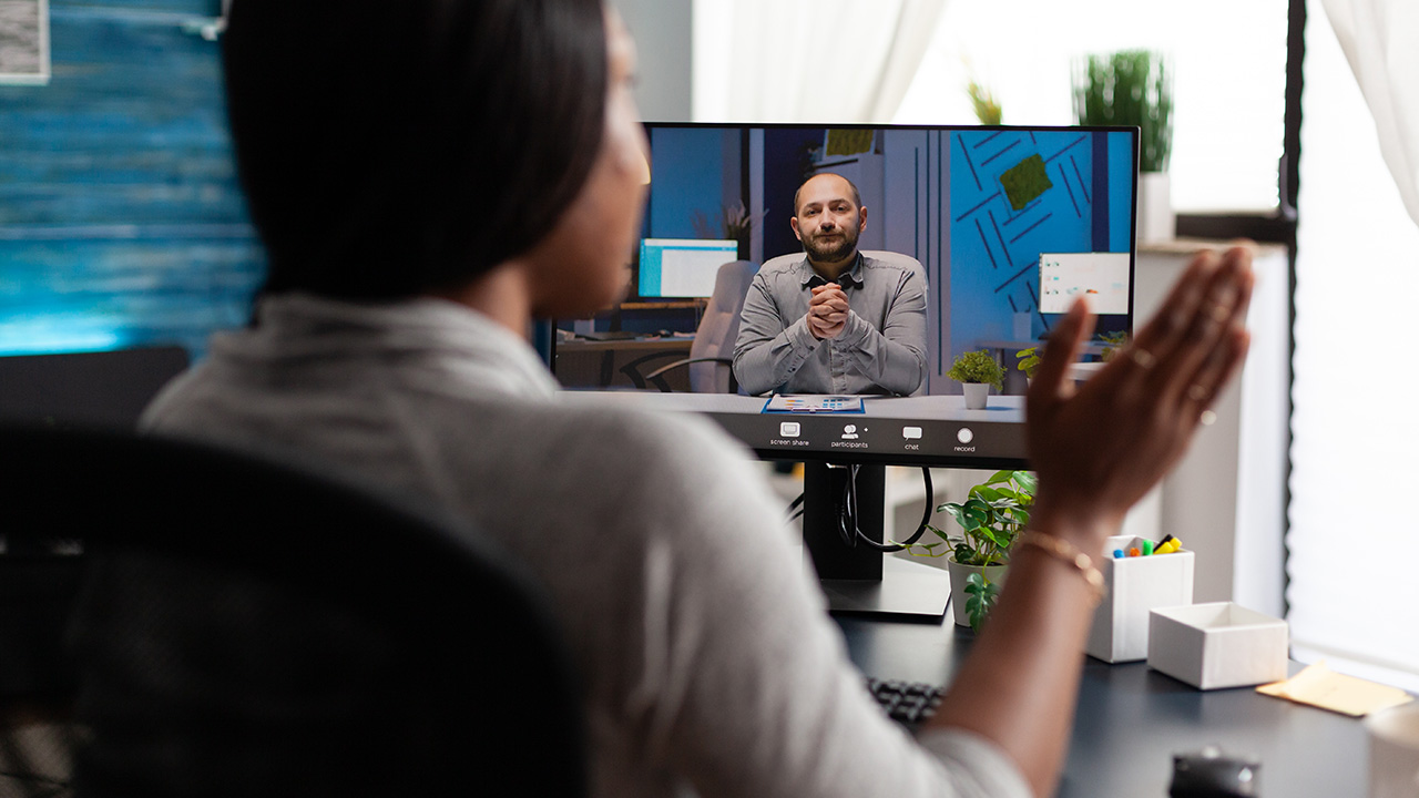 Woman discussing work with remote colleague