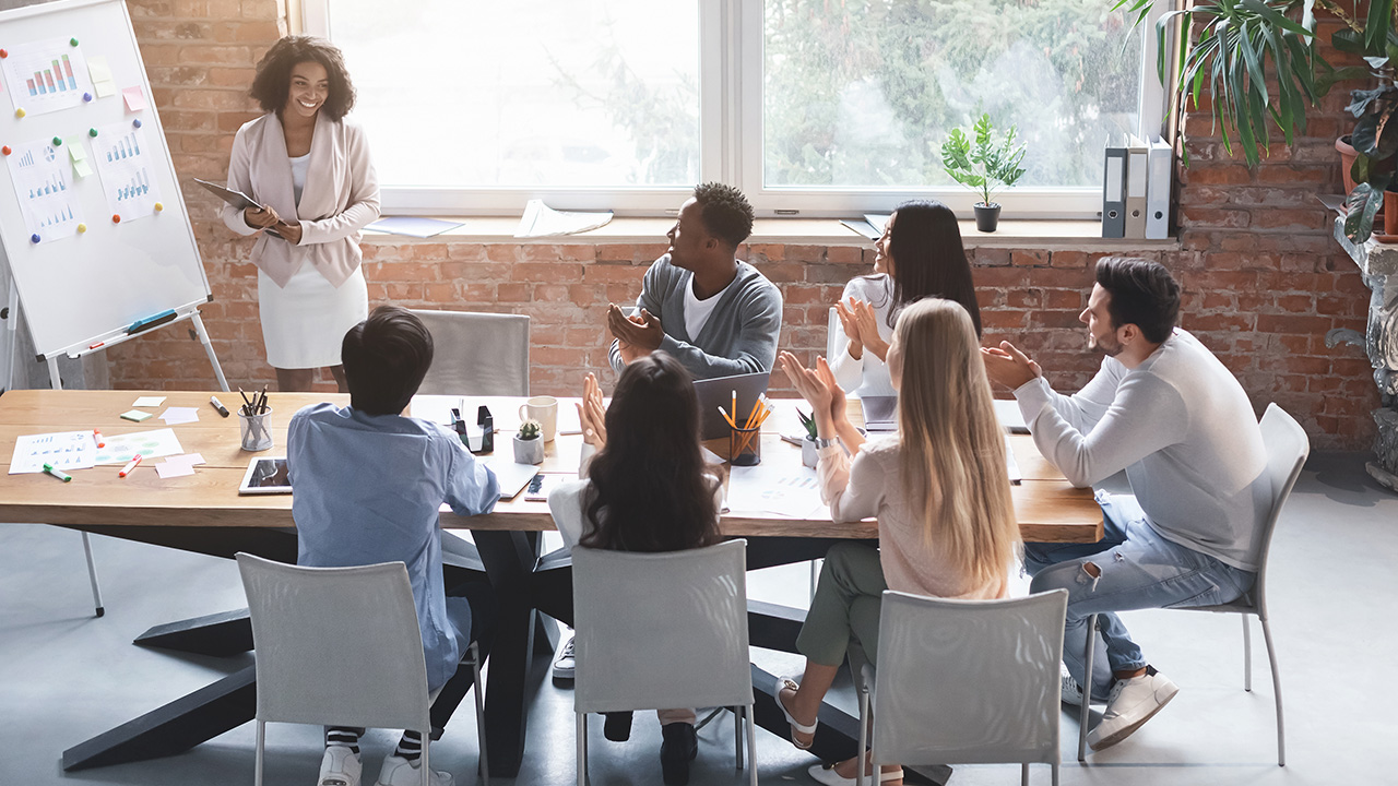 Woman making sales presentation to young international business team