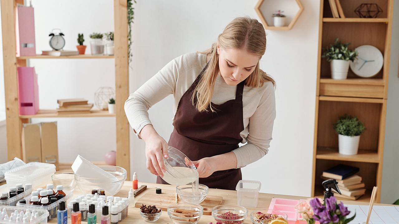 Small business owner in apron mixing something