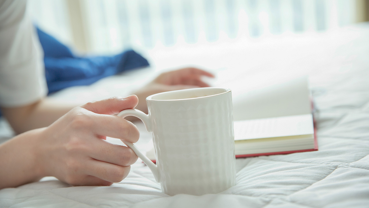 Reading a book with a cup of coffee