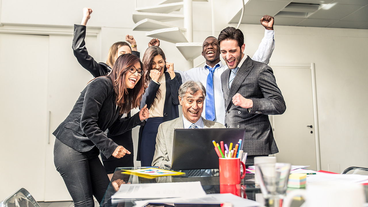 Business team in office cheering