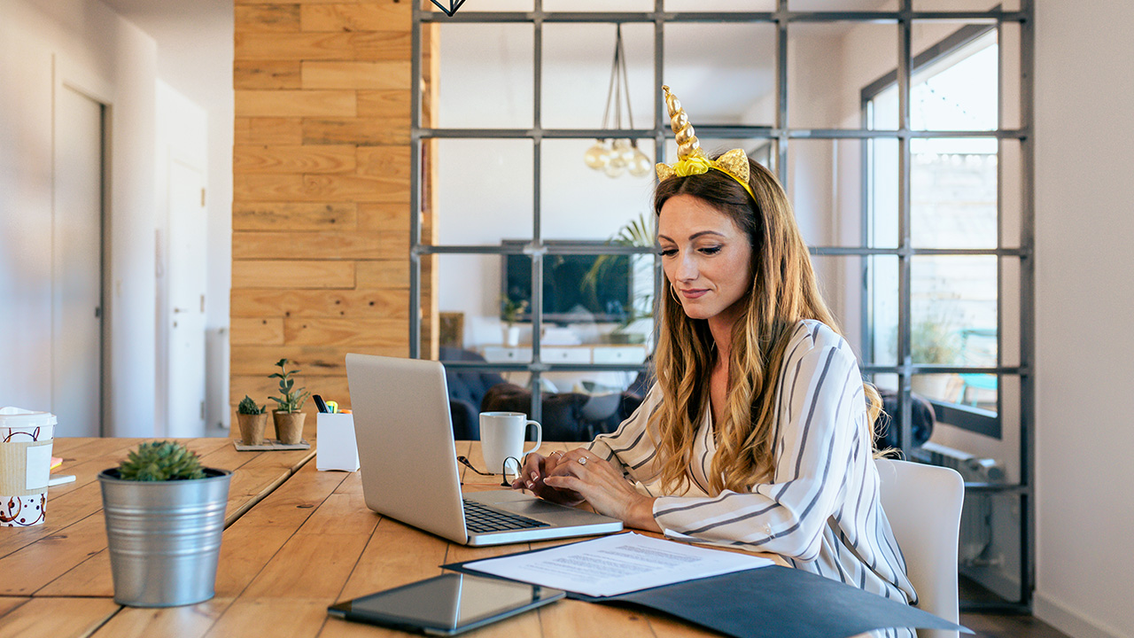 Business woman with unicorn headband working