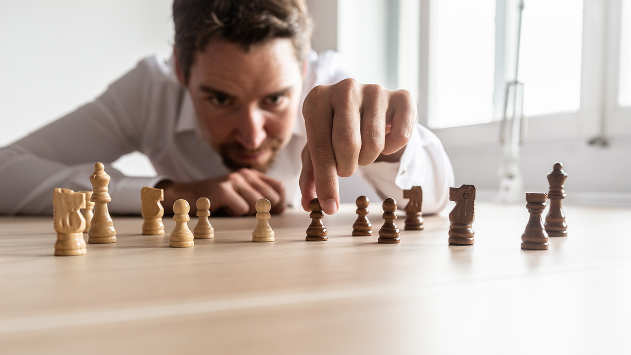 Businessman creating business strategy with chess pieces