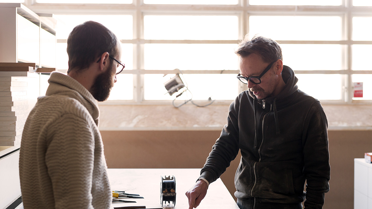 Carpenter talking to client in workshop