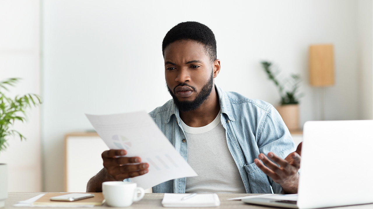 Concerned businessman checking financial reports