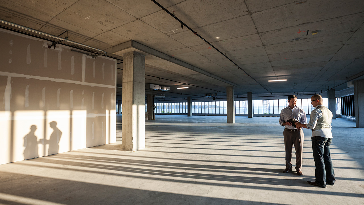 Business people looking at a new empty raw office space