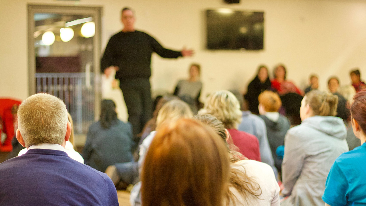 Man giving a speech on lessons learned in business