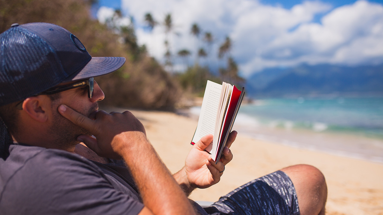 Entrepreneur man reading on the beach