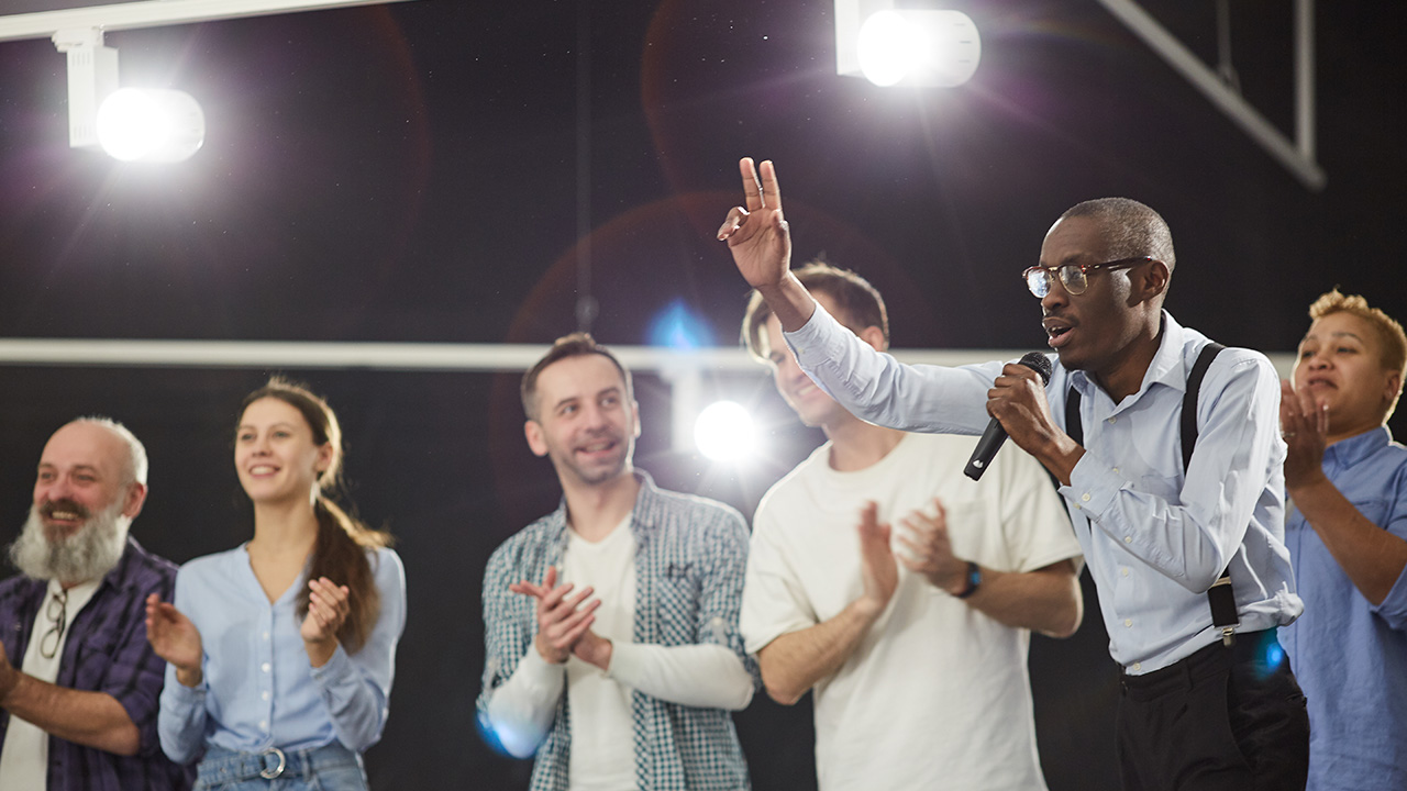 Man speaking at motivation seminar