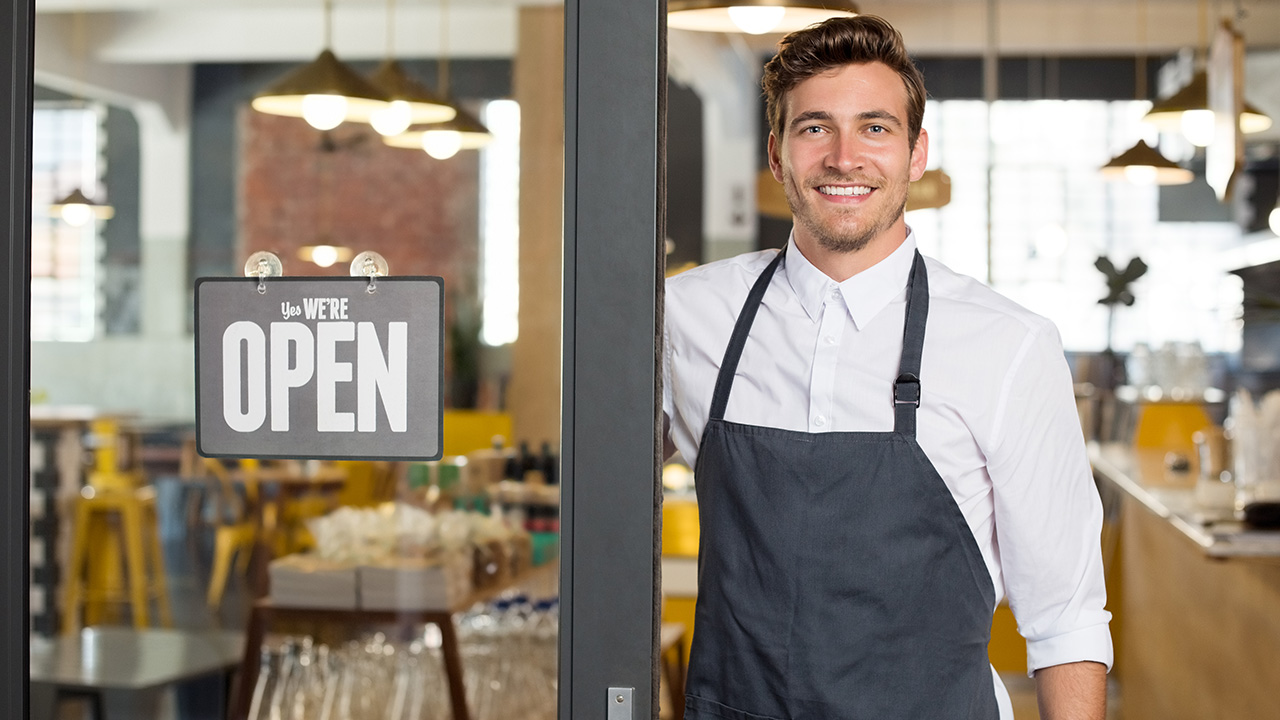 New small business owner smiling at his restaurant