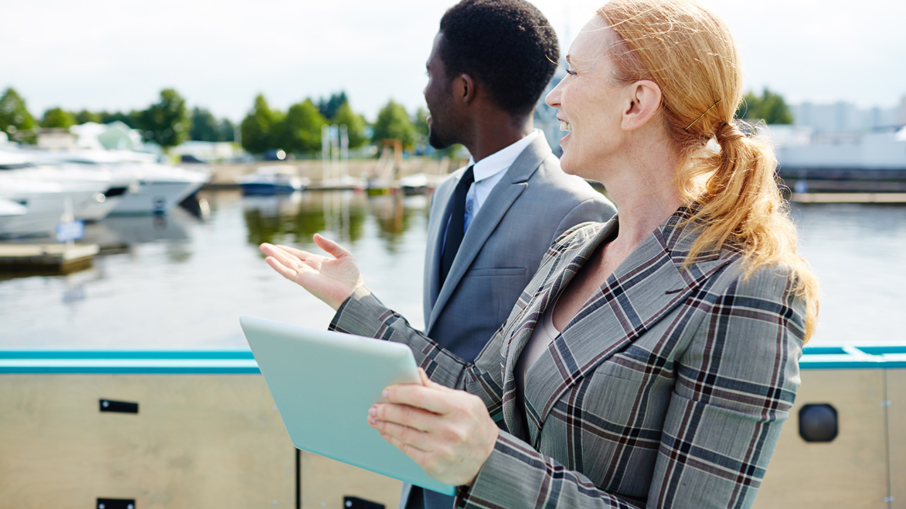 Contemporary business partners discussing view from their steamship