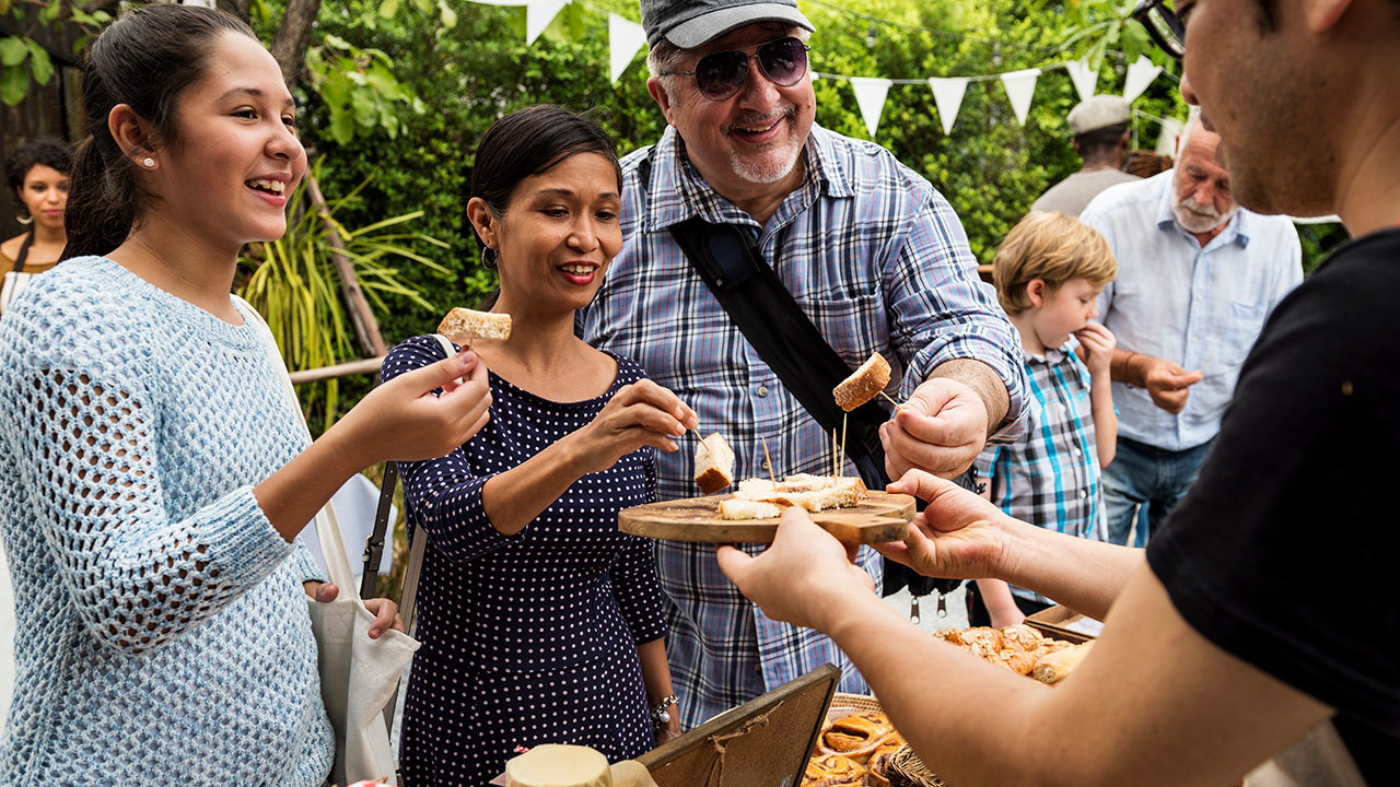 People enjoying a bite to eat at the local market