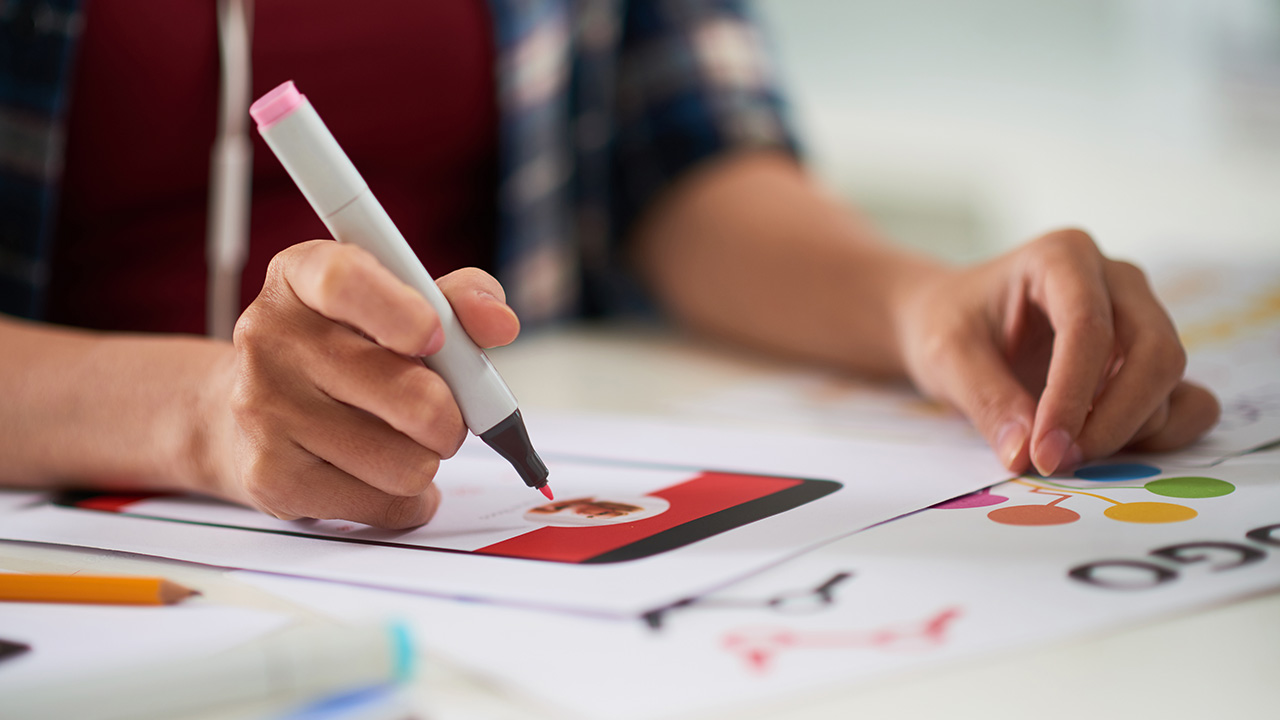 Manager sitting at office desk and preparing visual presentation