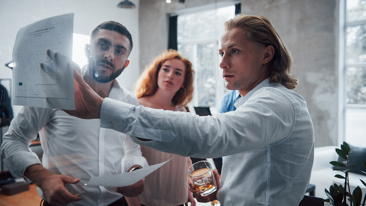 Young team in office looking at price list