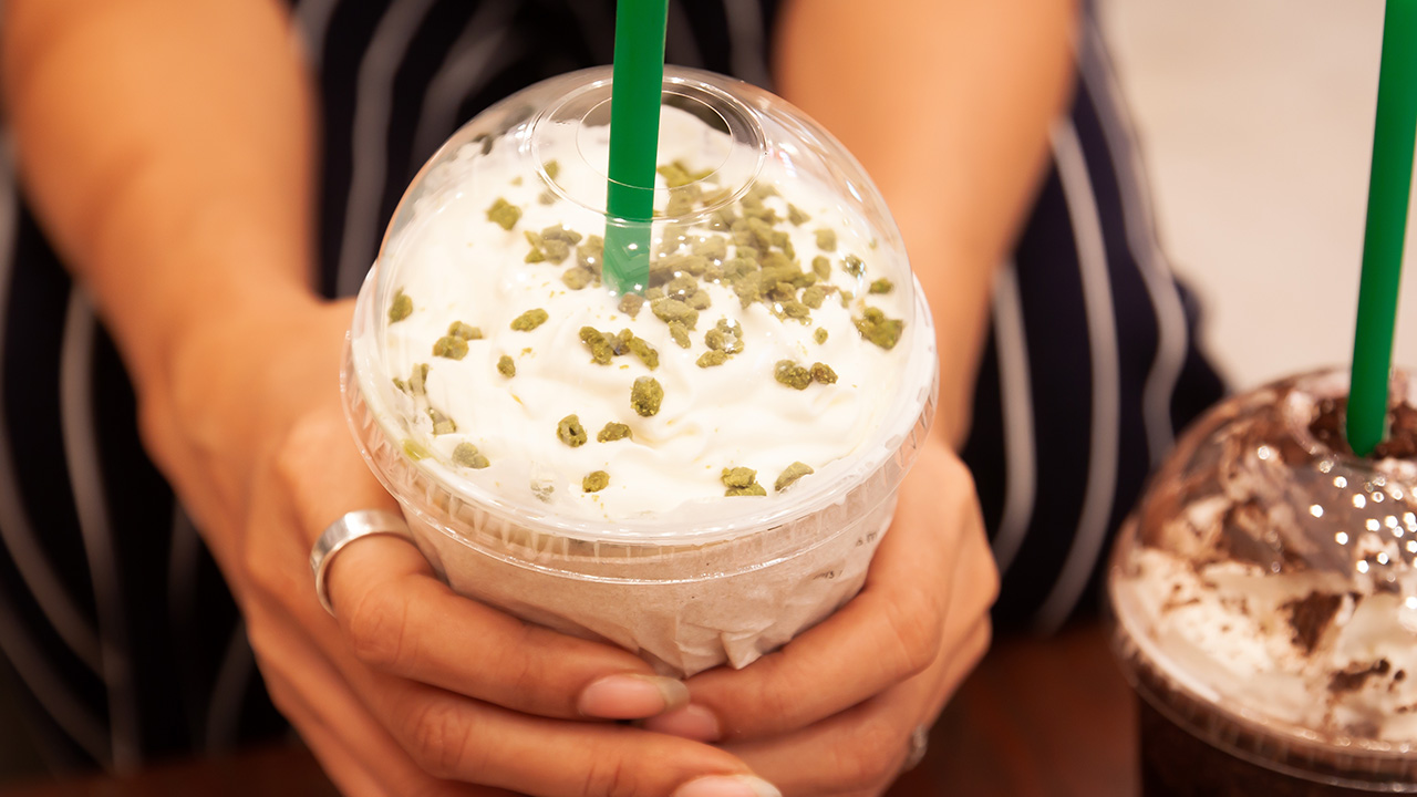 Starbucks Tea Ramisu Frappe with whipping cream in woman's hands