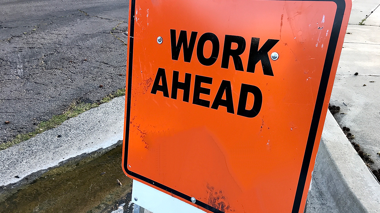 Road sign that reads WORK AHEAD