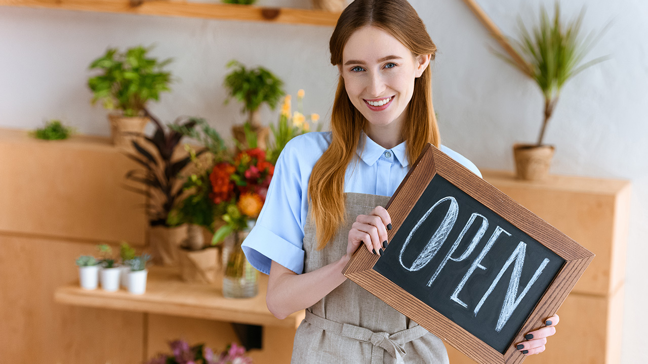 Flower Shop Woman Holding An OPEN Sign