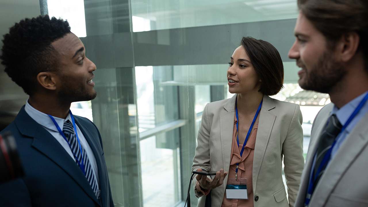 Business Colleagues Talking In An Elevator