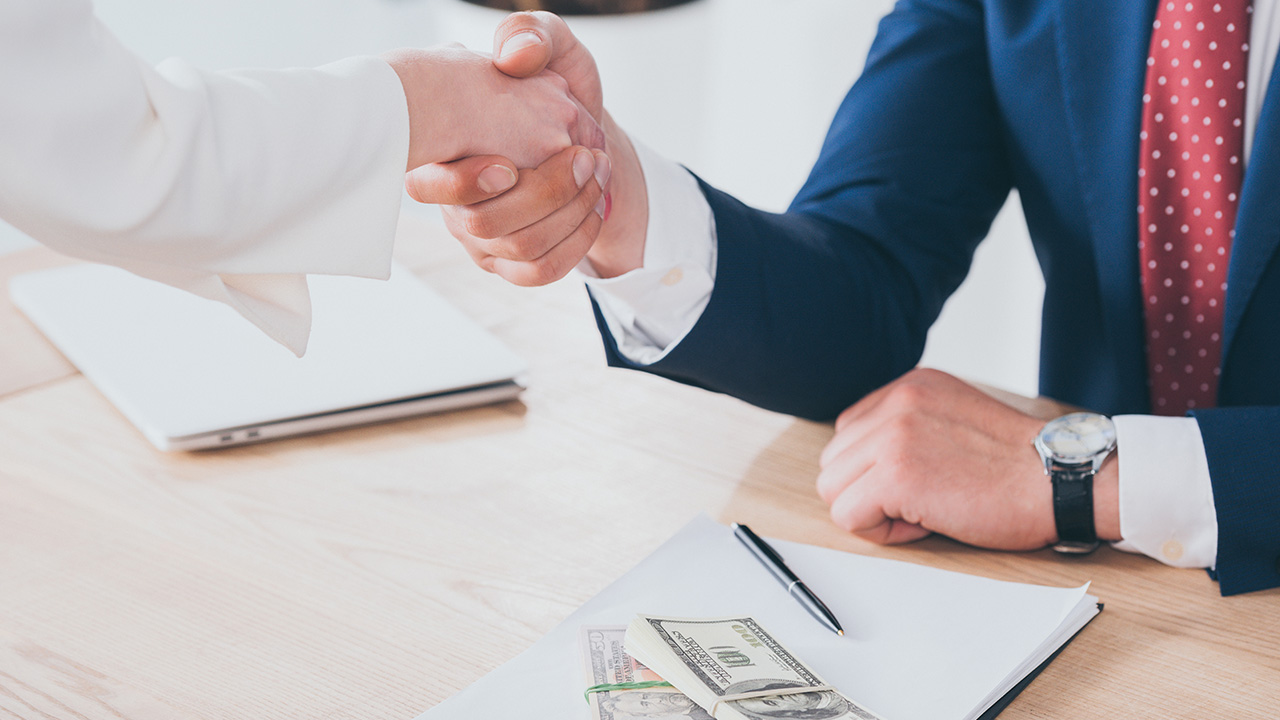 Business People Shaking Hands - Making a Deal for Invoice Factoring or Bank Loan?