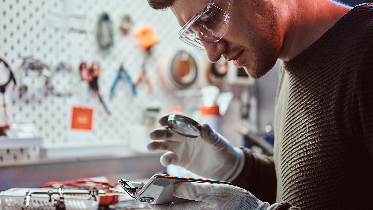 Electronic Technician Repairing Damaged Smartphone