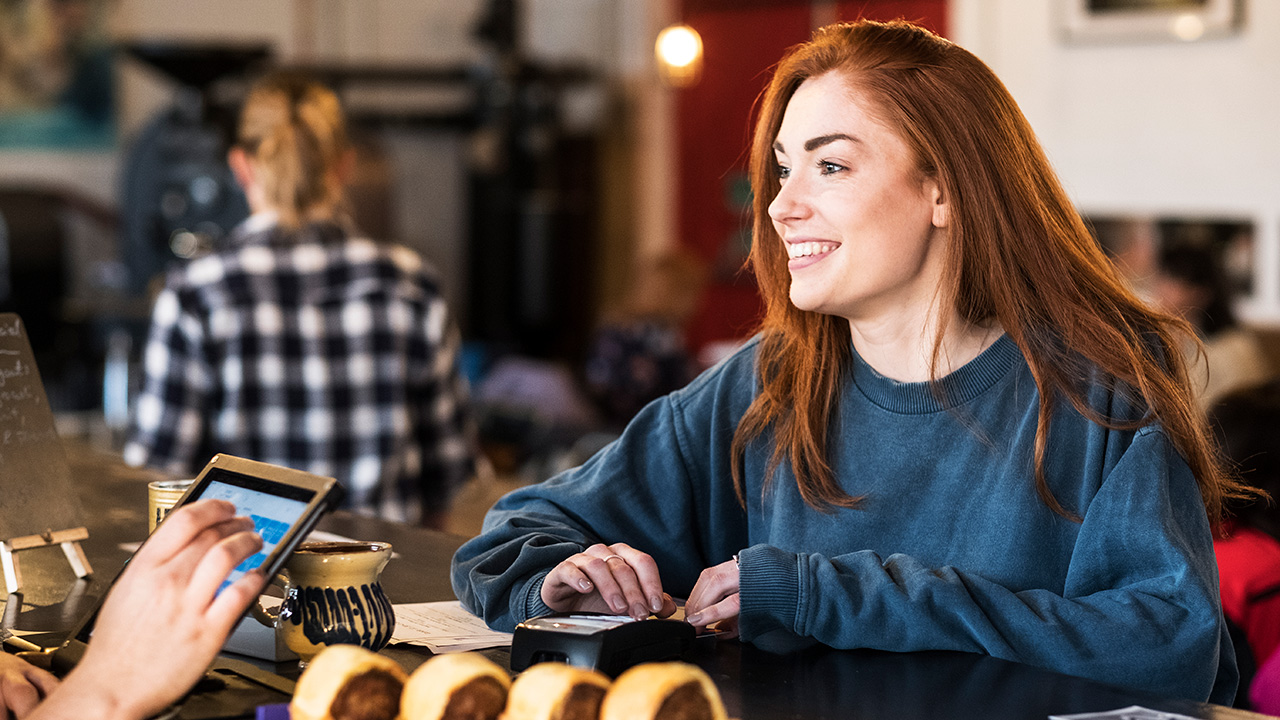 Woman Paying Her Bill at Restaurant Counter