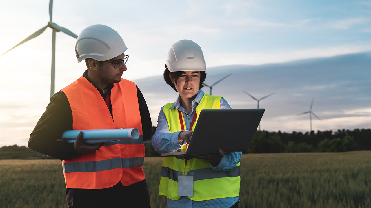 Engineers Working with Renewable Clean Energy on Wind Farm