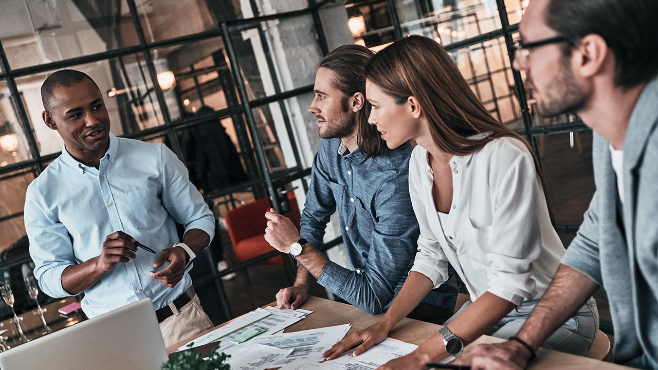 Four Business People Discussing the 4-Day Work Week