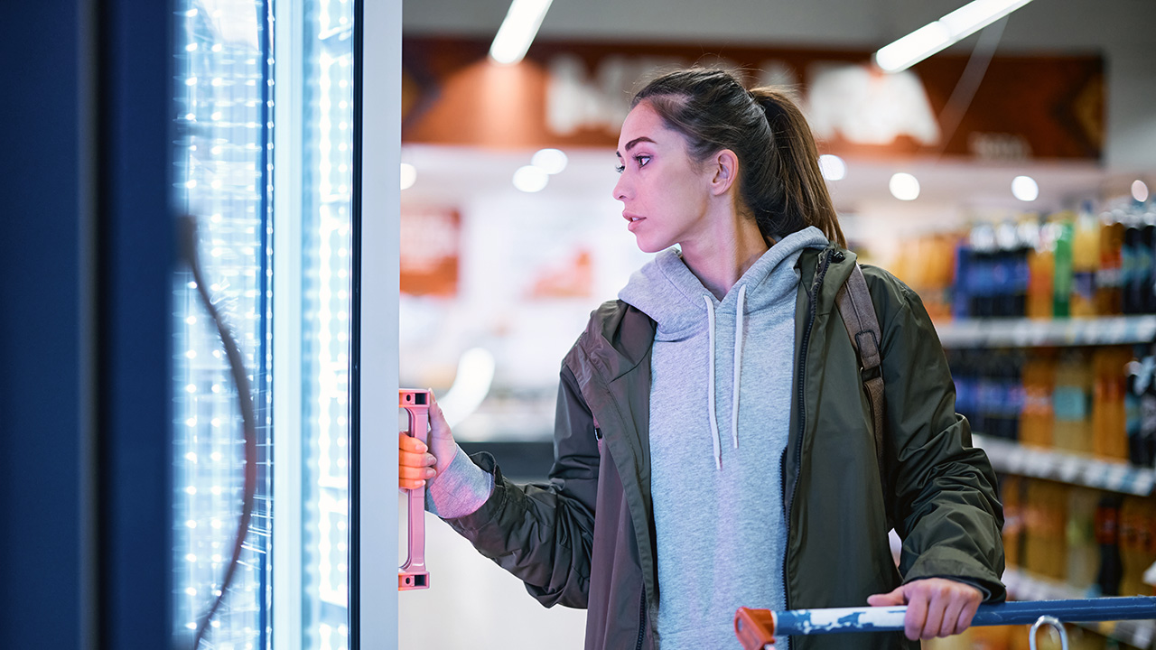 Woman Shopping for Frozen Dinners in the Grocery Store