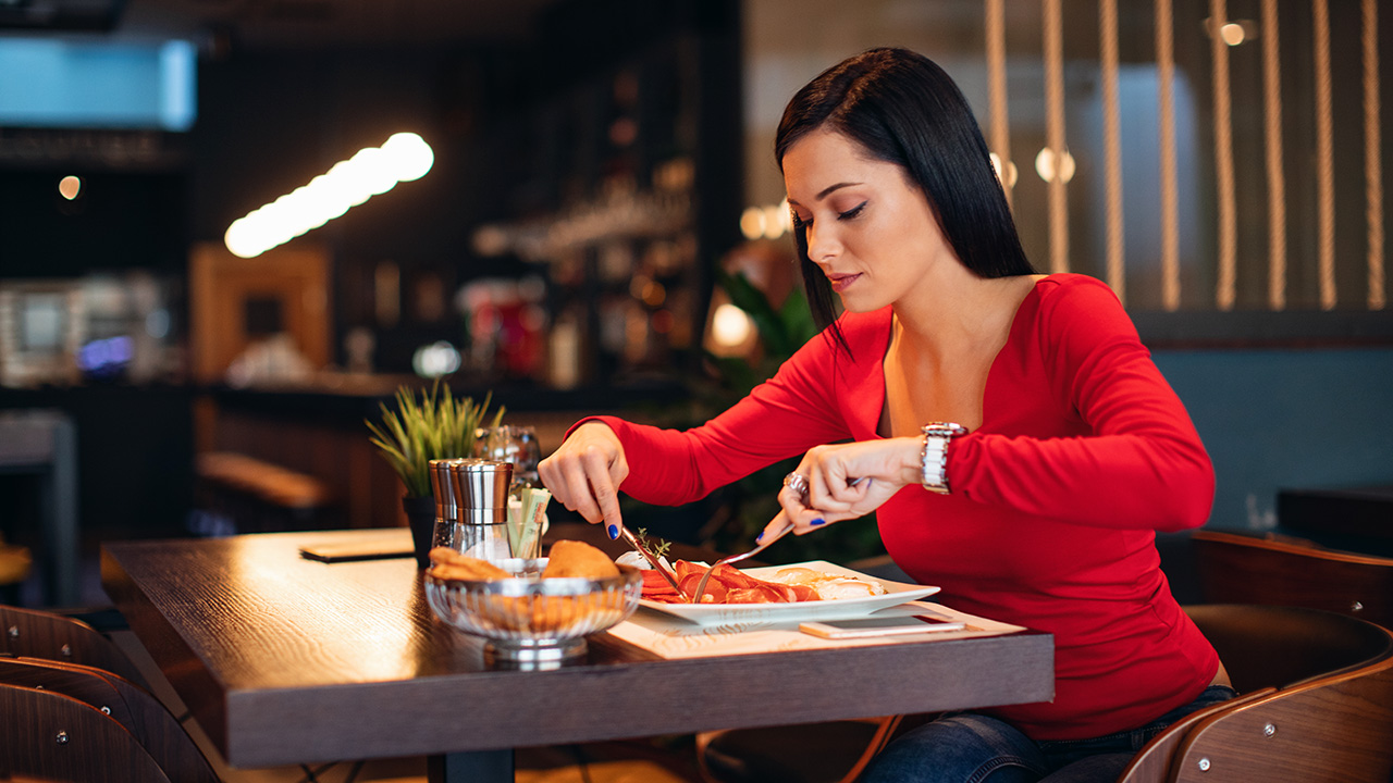 Young Woman Eating at a Healthy Restaurant