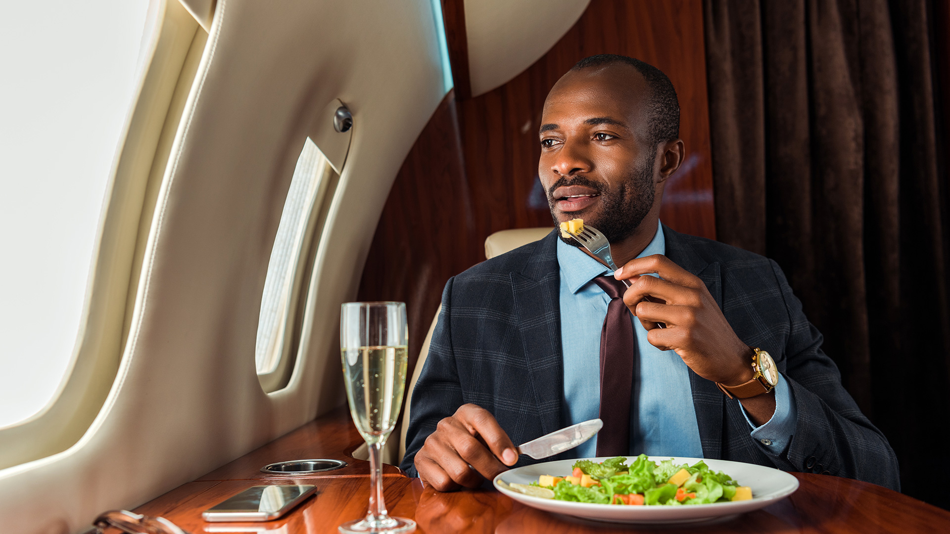 Business Man Eating Salad in Private Jet