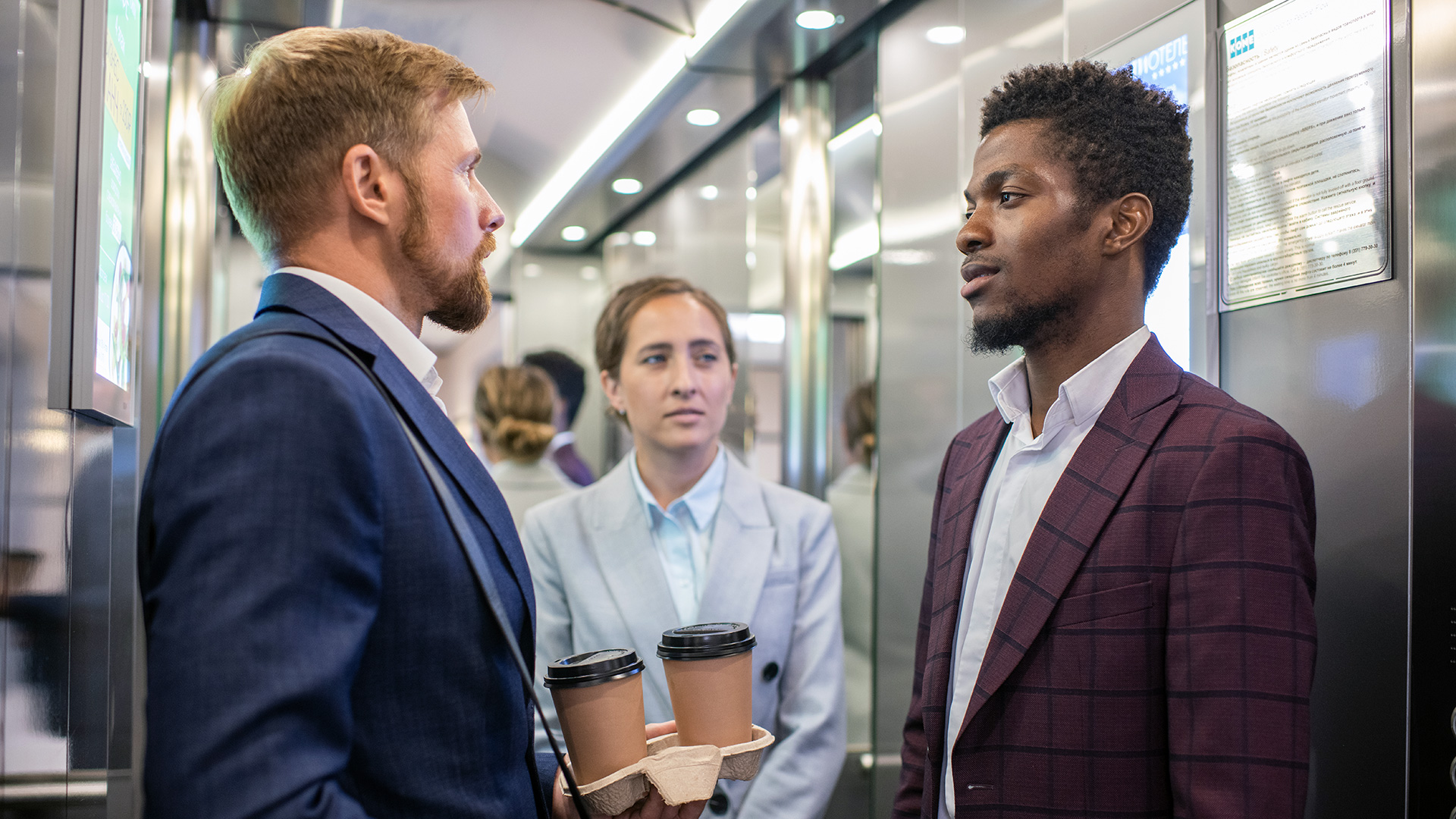 Business People Talking in an Elevator