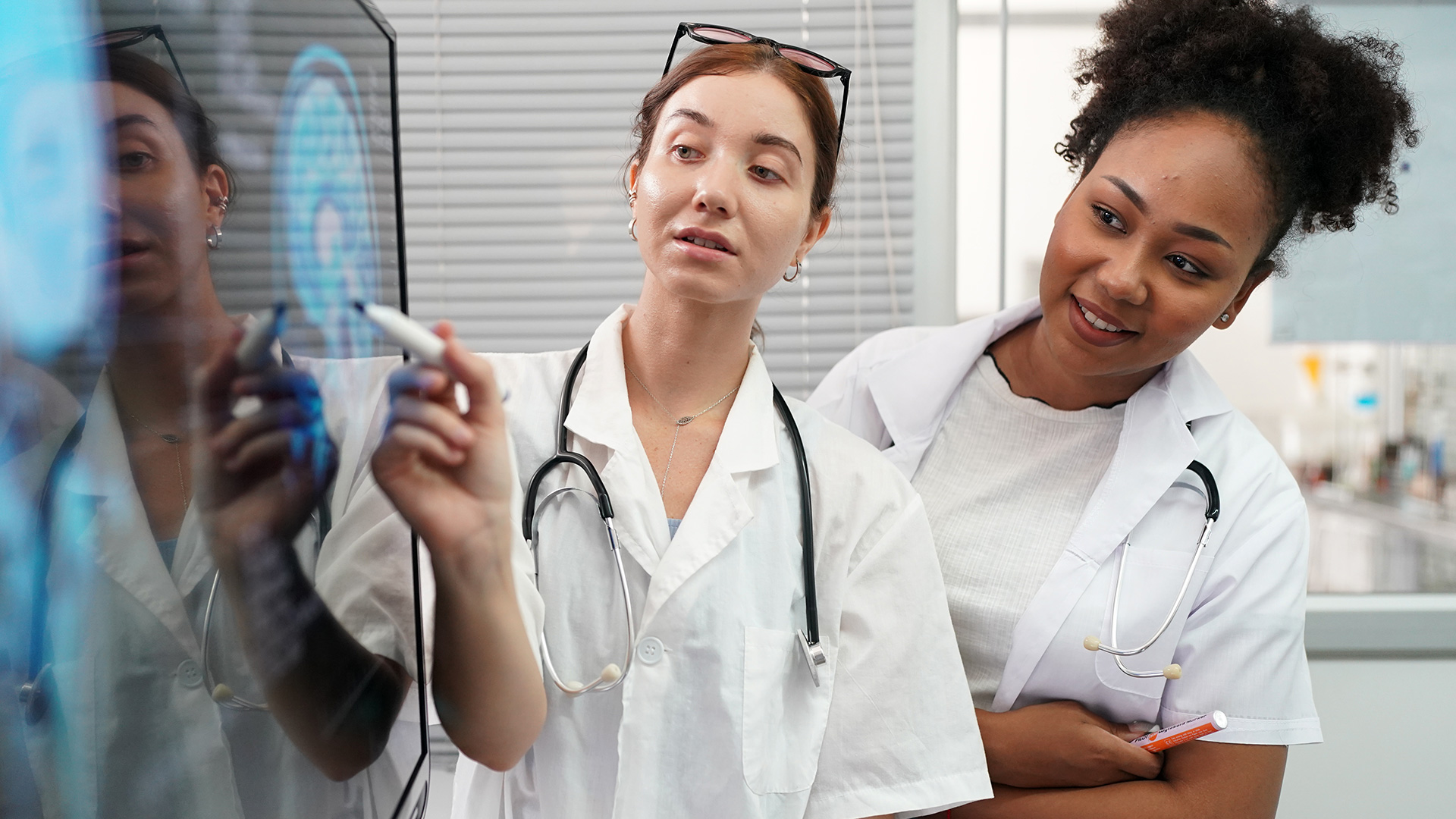 Two Women Doctors Looking at X-Ray